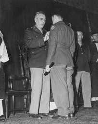 Major Howard B. Smith Pins an Award to a Soldiers Uniform