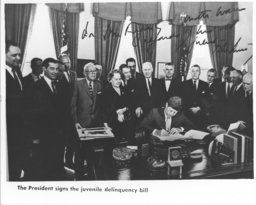 John F. Kennedy, President of the United States, signs the Juvenile Deliquency Bill