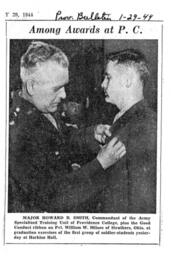Major Howard B. Smith, Commmandant of ASTP, Pins the Good Conduct Ribbon on Pvt. William W. Milnes